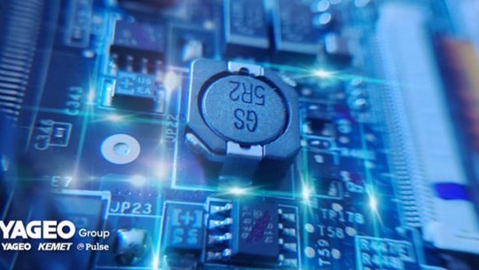 A detailed view of electronic components on a circuit board, featuring a visible capacitor