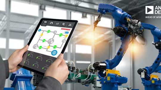 A modern industrial setting featuring robotic arms in operation, controlled through a tablet interface displaying a system diagram.