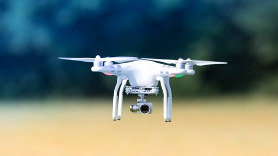 Image of white drone flying in outdoor setting