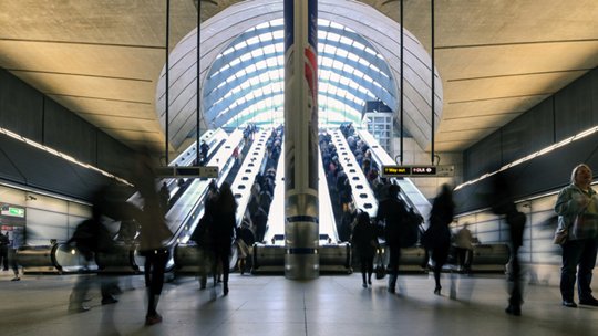 Image of commuters inside Canary Wharf Station in London