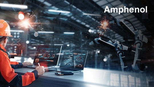 A factory engineer wearing a safety helmet and reflective jacket observes robotic arms performing welding tasks