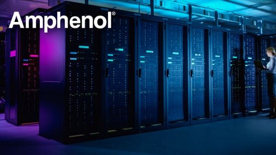 A modern server room illuminated with blue and purple lighting, featuring rows of data servers. A technician is seen working on a laptop, emphasizing a professional and technological environment. The Amphenol logo is clearly visible in the top left corner.