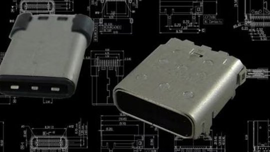 Two USB-C connectors are displayed against a black background featuring detailed technical schematics. 