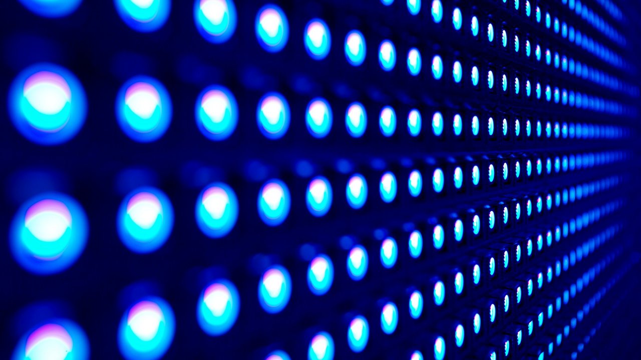 A detailed view of a grid of illuminated blue LED lights, arranged in a repetitive pattern