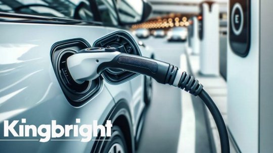 A modern electric vehicle is plugged into a charging station labeled 'Kingbright' in a sleek urban setting