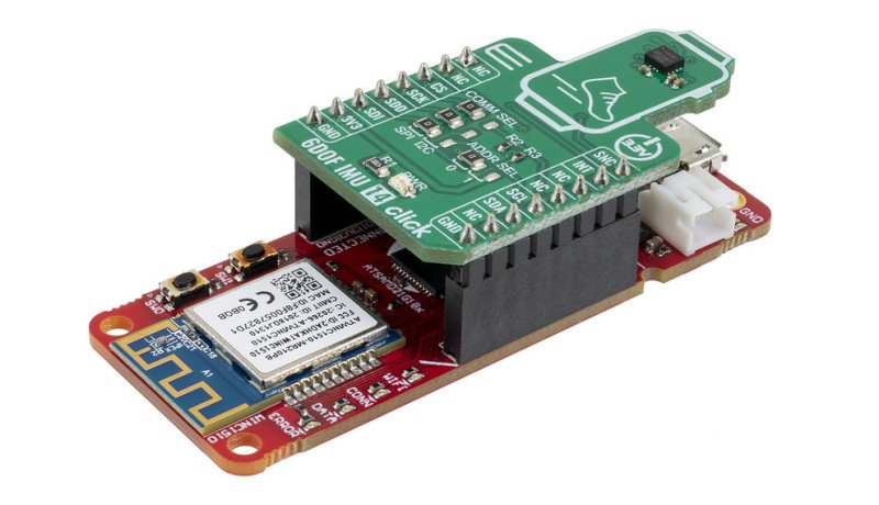A compact electronic module featuring two stacked circuit boards, one red and one green