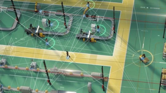 A high-tech factory floor showcasing automated machinery and workers interacting with advanced systems