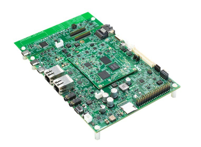 A detailed green circuit board featuring various electronic components, including chips, capacitors, and connectors