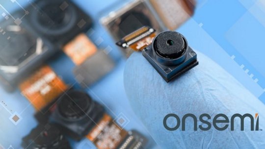 A detailed view of a small camera sensor module held by a gloved hand, showcasing intricate electronic components