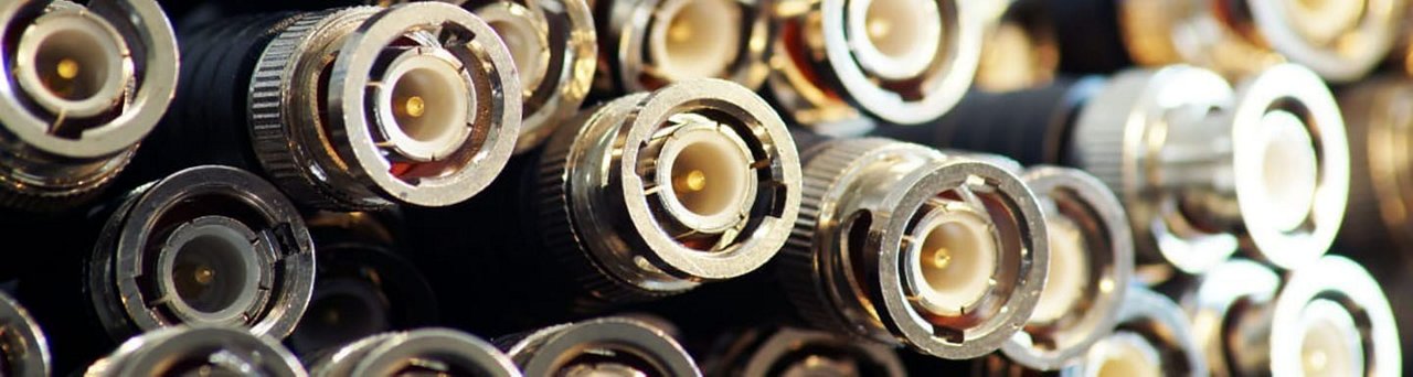 A detailed view of multiple coaxial cable connectors arranged closely together.