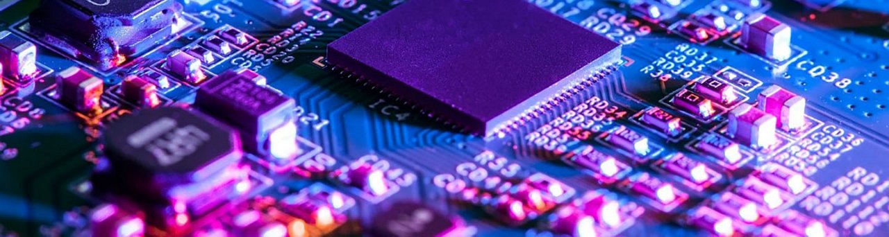 A detailed view of a circuit board featuring a central microchip surrounded by various electronic components.