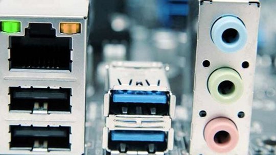 Computer motherboard ports, including network, USB, and audio jacks.