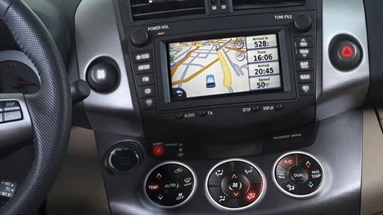 Car dashboard with navigation system, climate controls, and time display.