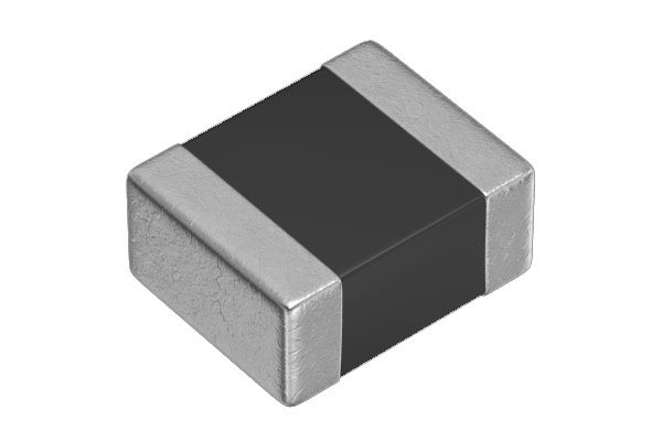 A close-up view of a small electronic component featuring a rectangular shape with metallic edges and a black central body