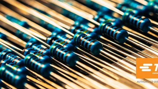 Close-up of electronic resistors and TE logo