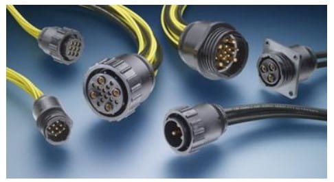 A collection of industrial-grade electrical connectors displayed on a blue surface.