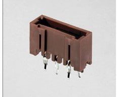 A close-up image of a brown rectangular electrical connector with multiple metal pins