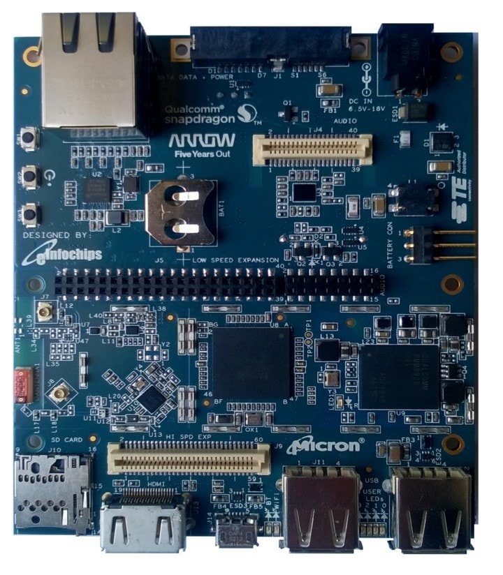 A Qualcomm Snapdragon development board featuring various electronic components and connectors. The board includes visible branding from Micron and Arrow, along with text such as 'Five Years Out' and 'Designed by eInfochips.' Key features include USB ports, Ethernet connectors, and expansion slots. Numeric details like '15V-18V' and 'AL010' are clearly visible on the board.