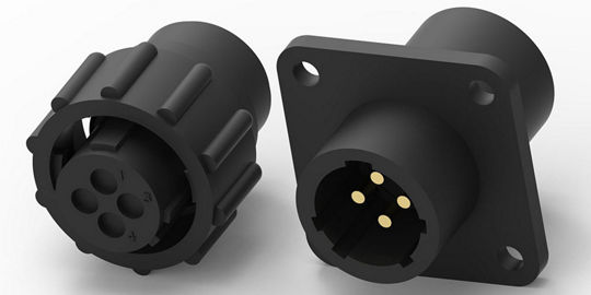 Two black circular electrical connectors are displayed, featuring a 4-pin configuration. 