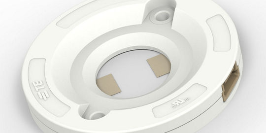 A white circular mounting base designed for secure installations. 