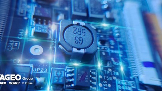 A detailed view of electronic components on a circuit board, featuring a visible capacitor
